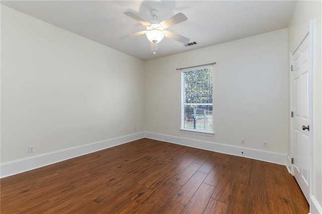 spare room with ceiling fan, wood finished floors, visible vents, and baseboards