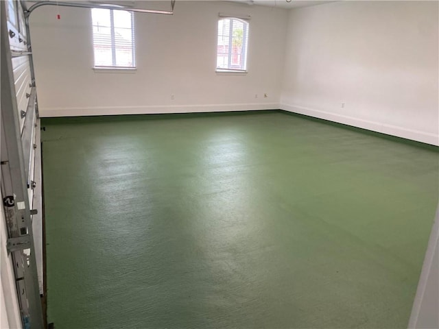 empty room featuring finished concrete floors and baseboards