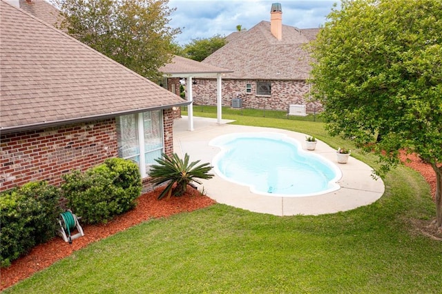 outdoor pool with a patio, central air condition unit, and a lawn