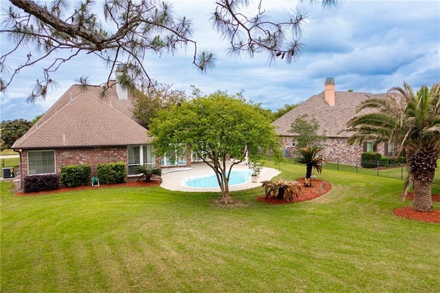 view of yard featuring an outdoor pool and fence