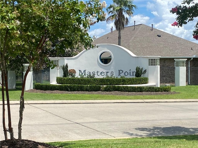 community / neighborhood sign with fence