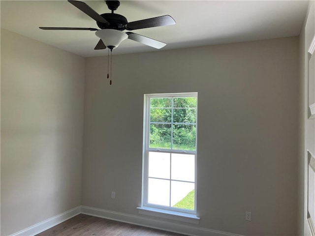 spare room featuring ceiling fan, light hardwood / wood-style floors, and a wealth of natural light