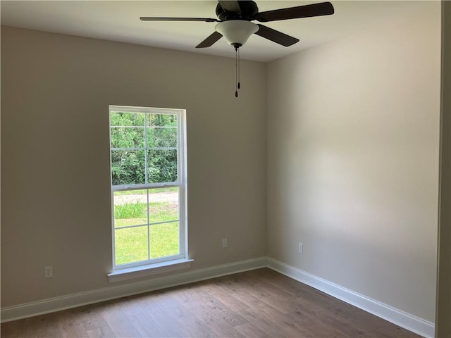 unfurnished room with hardwood / wood-style flooring and ceiling fan