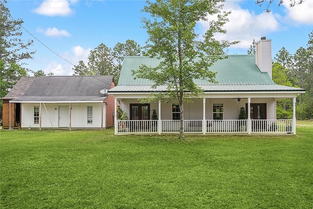 rear view of property with a yard