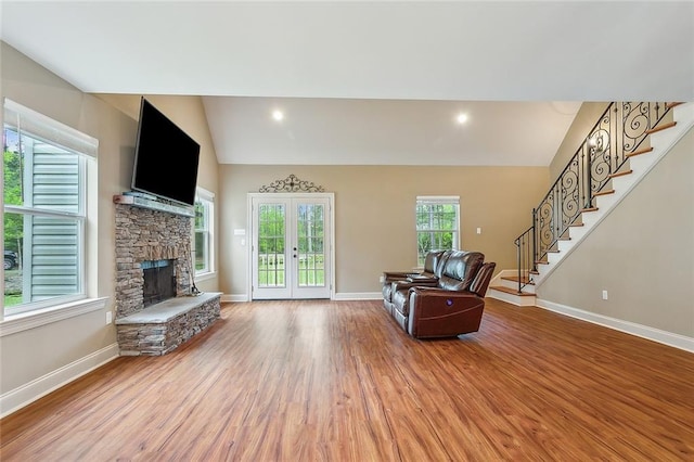 kitchen featuring light hardwood / wood-style floors, appliances with stainless steel finishes, hanging light fixtures, and a center island