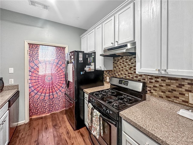 kitchen with gas stove, dark wood-type flooring, white cabinetry, stainless steel dishwasher, and backsplash