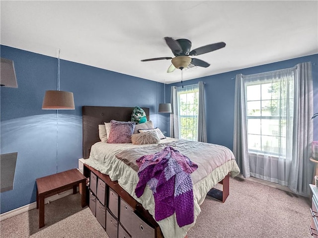 bedroom with ceiling fan and light colored carpet