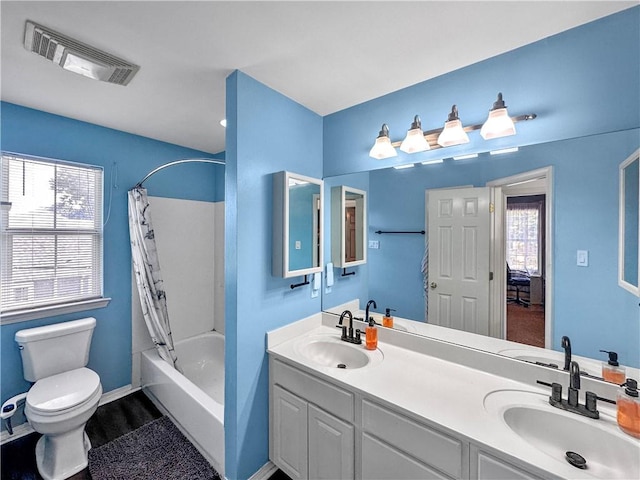 full bathroom with shower / bath combo with shower curtain, double vanity, and toilet