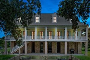 back of property featuring a balcony and a patio