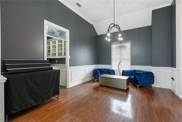 bedroom with crown molding, dark hardwood / wood-style flooring, and vaulted ceiling