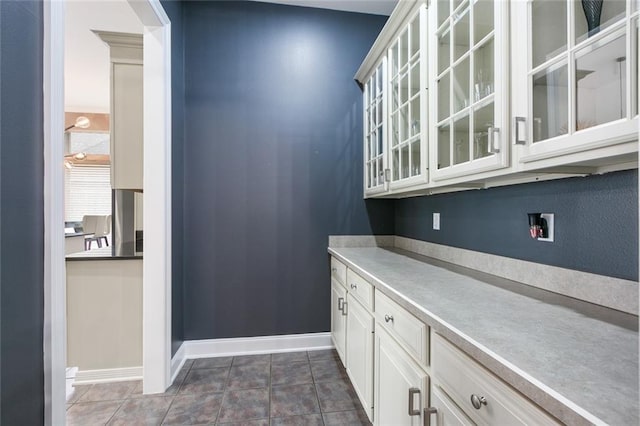 kitchen with white cabinetry and dark tile flooring
