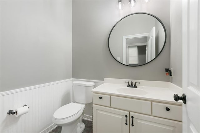 bathroom featuring toilet and vanity