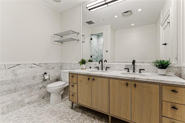 bathroom featuring vanity, tile walls, and toilet