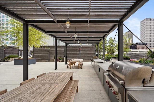 view of patio / terrace with area for grilling and a pergola