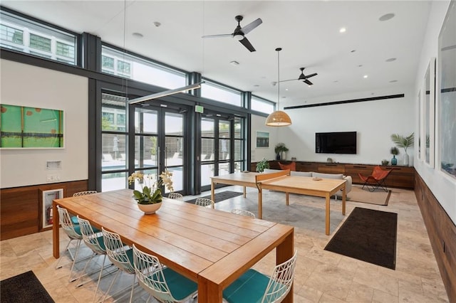 dining area featuring a wall of windows and ceiling fan