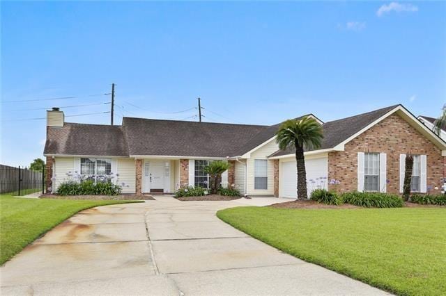 ranch-style house with a garage and a front lawn