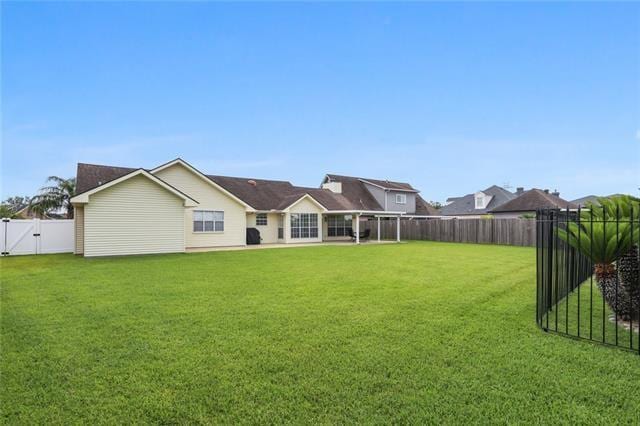 back of house with a lawn