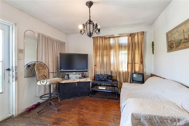 living room featuring dark wood-type flooring and a chandelier