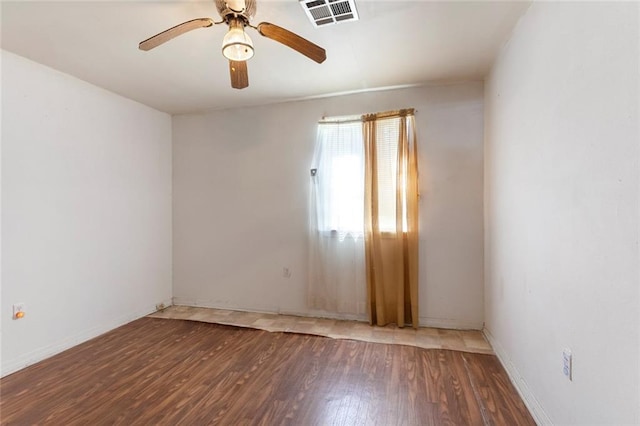 empty room with dark hardwood / wood-style floors and ceiling fan