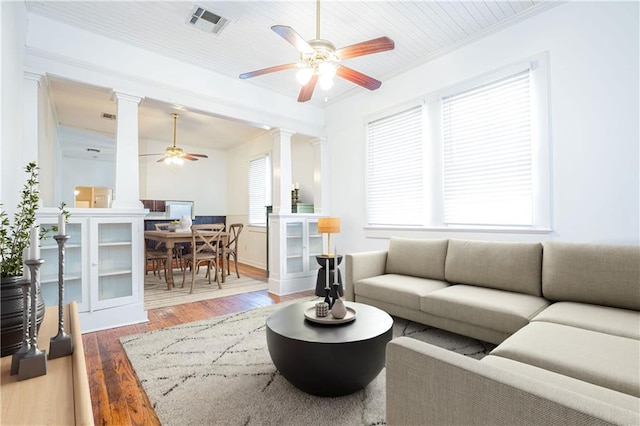 living room featuring ceiling fan, hardwood / wood-style flooring, and crown molding