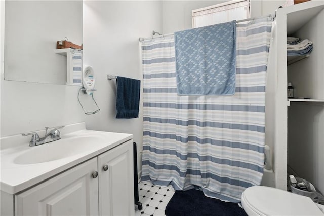 bathroom featuring vanity, a shower with curtain, and toilet