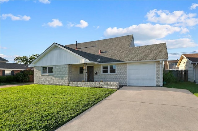 view of front of property featuring a garage and a front lawn