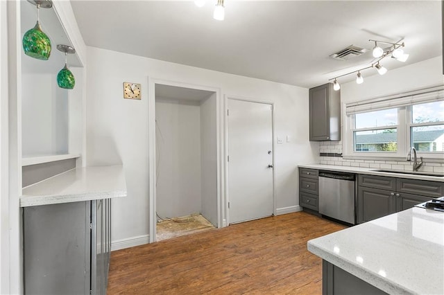 kitchen featuring gray cabinetry, dishwasher, wood-type flooring, and sink