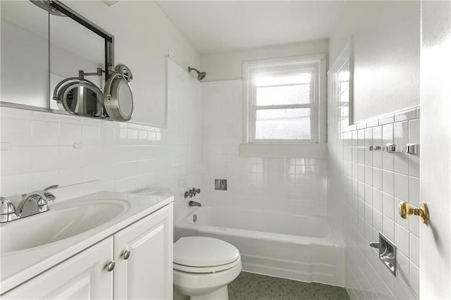 bathroom featuring vanity, tile walls, and toilet