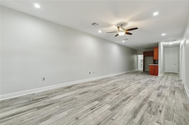 unfurnished living room featuring ceiling fan and light wood-type flooring