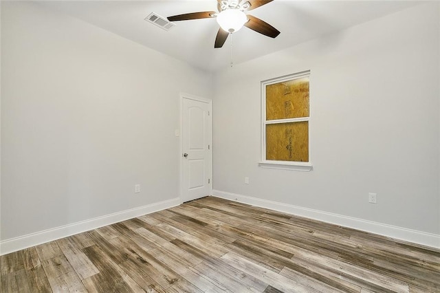 spare room with hardwood / wood-style flooring and ceiling fan