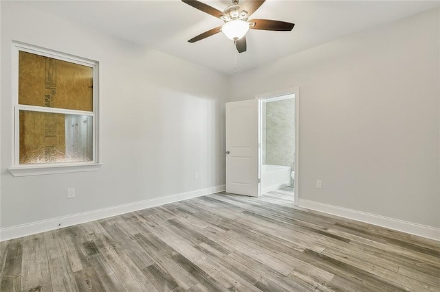 spare room with ceiling fan and light wood-type flooring