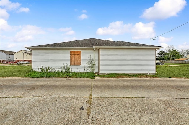 view of side of home featuring a yard