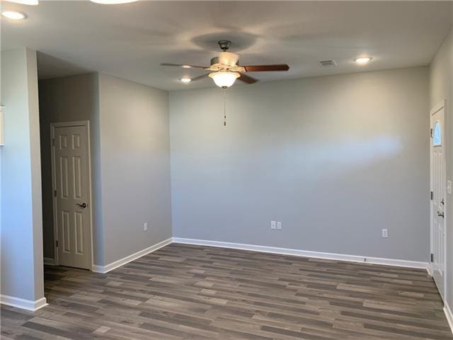 empty room featuring ceiling fan and dark hardwood / wood-style floors