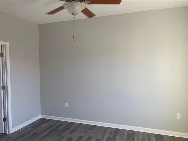 empty room featuring dark hardwood / wood-style flooring and ceiling fan