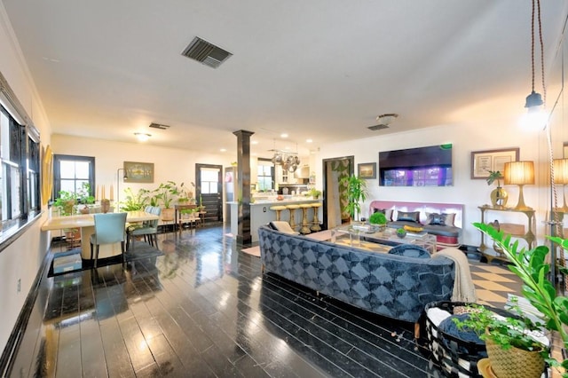 living room featuring dark hardwood / wood-style flooring and ornate columns