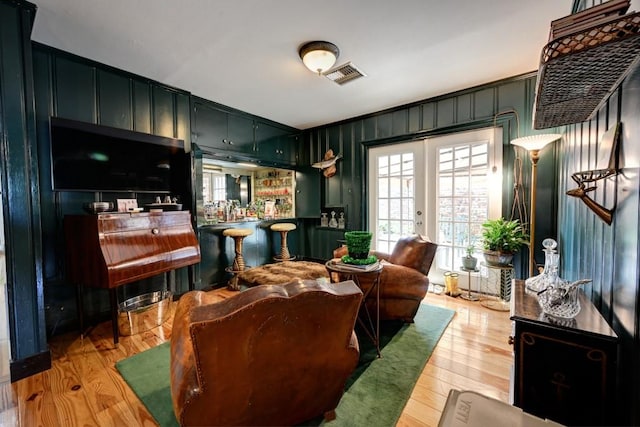 living room featuring french doors and light hardwood / wood-style floors