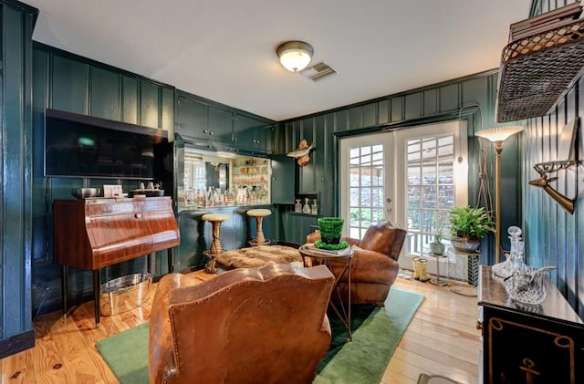 sitting room featuring light hardwood / wood-style flooring and french doors