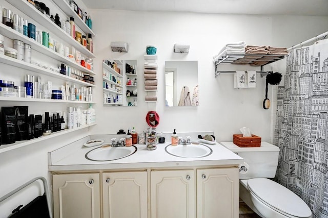 bathroom featuring dual bowl vanity and toilet