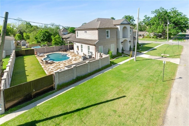 view of property's community with a patio, a lawn, and a swimming pool