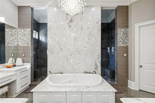 bathroom featuring vanity, crown molding, tile walls, a chandelier, and a tub