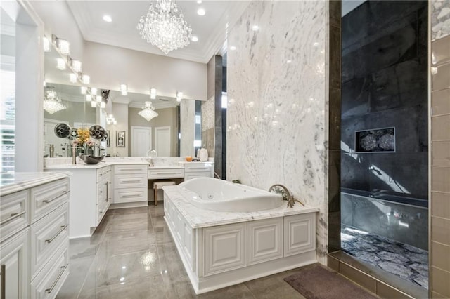 bathroom with a bath, a chandelier, vanity, tile walls, and ornamental molding