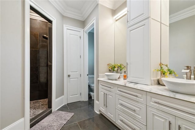 bathroom featuring vanity, toilet, a shower, and crown molding