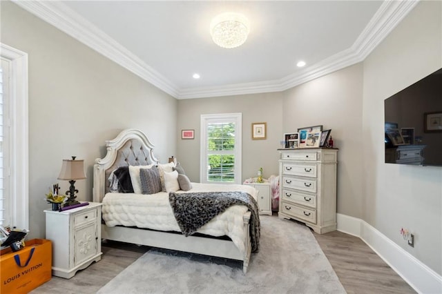 bedroom with ornamental molding and light hardwood / wood-style flooring