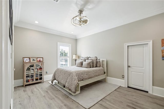 bedroom featuring crown molding and light wood-type flooring