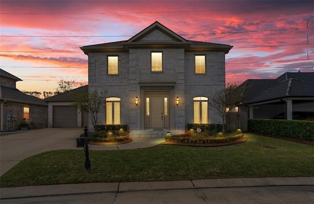 view of front of home with a lawn and a garage