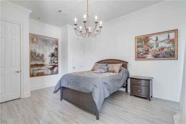 bedroom featuring ornamental molding, light hardwood / wood-style floors, and a chandelier