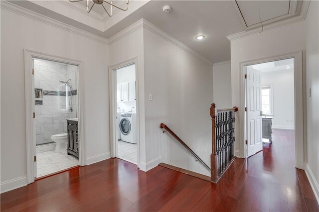 interior space with washer / clothes dryer, ornamental molding, and dark tile flooring