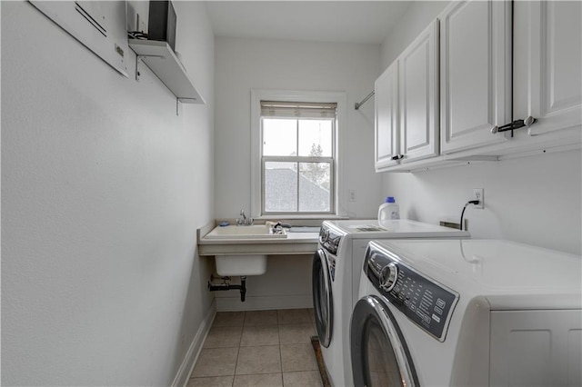 laundry room with cabinets, hookup for a washing machine, separate washer and dryer, and light tile floors