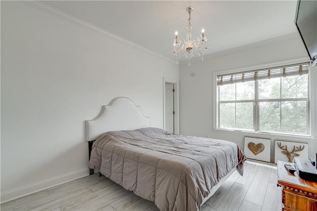 bedroom featuring ornamental molding, light hardwood / wood-style flooring, and a chandelier