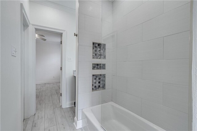 bathroom featuring wood-type flooring and tiled shower / bath combo